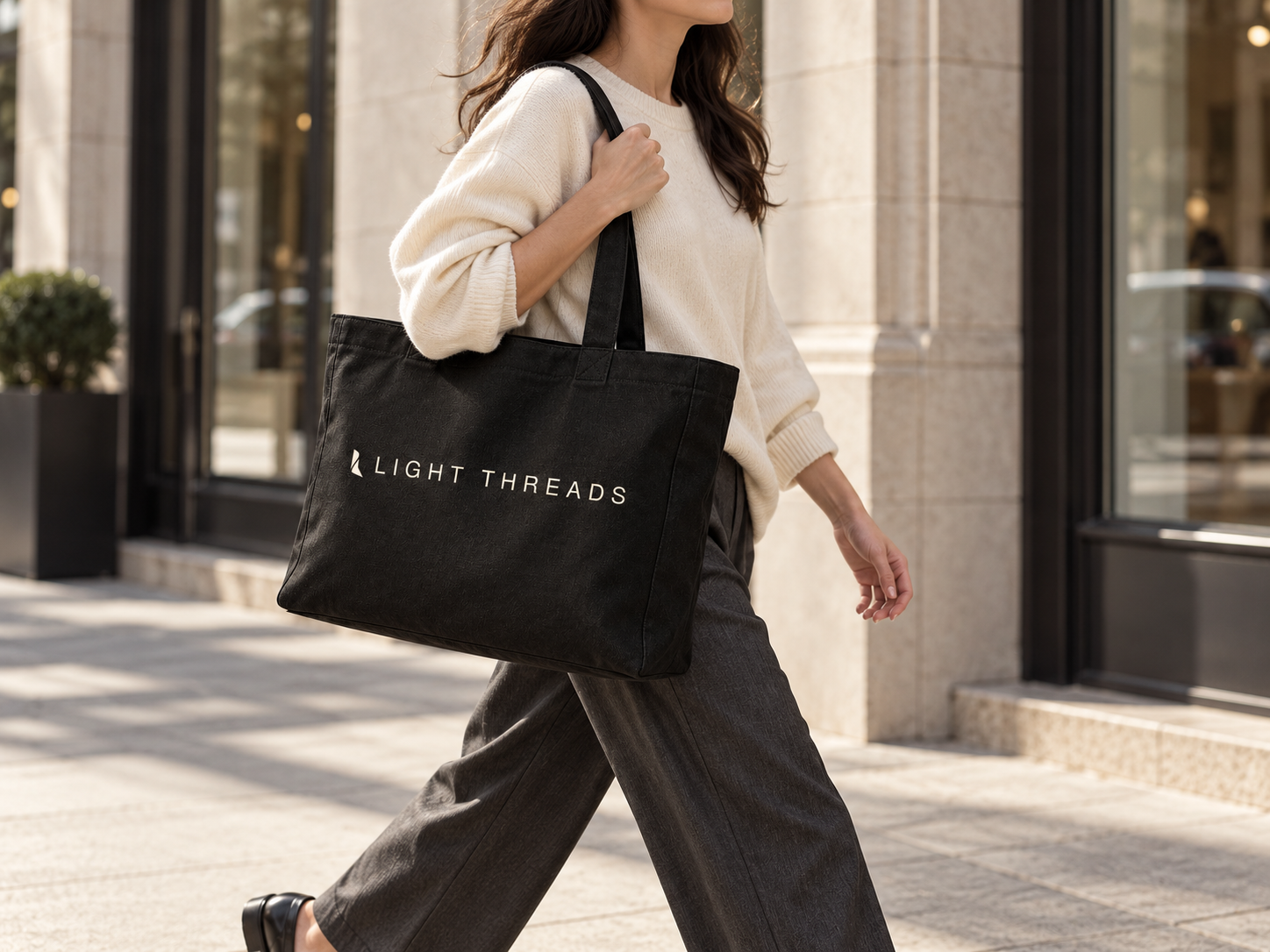 Woman carrying the Light Threads tote in motion